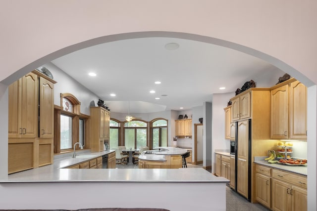 kitchen featuring sink, paneled fridge, black dishwasher, kitchen peninsula, and a kitchen island