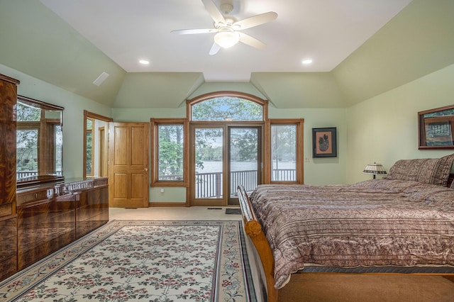 carpeted bedroom featuring access to outside, vaulted ceiling, and ceiling fan