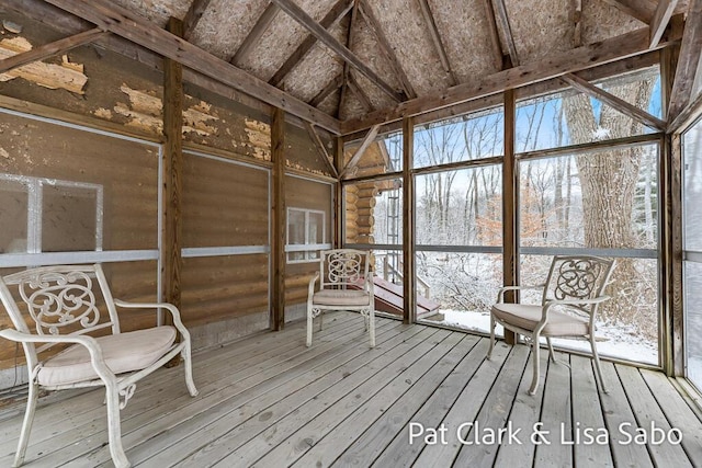 unfurnished sunroom featuring vaulted ceiling