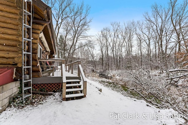 snowy yard with a wooden deck