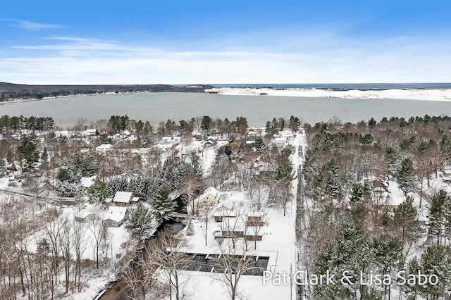 snowy aerial view with a water view