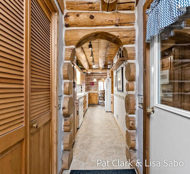 hall featuring log walls and wood ceiling