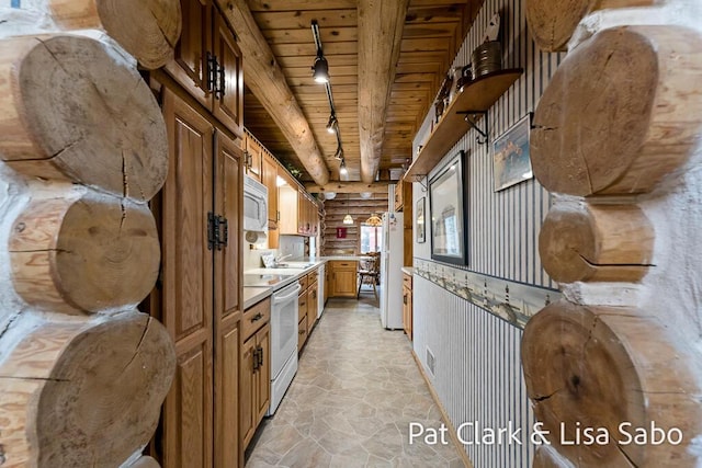 kitchen with sink, wooden ceiling, beamed ceiling, track lighting, and white appliances