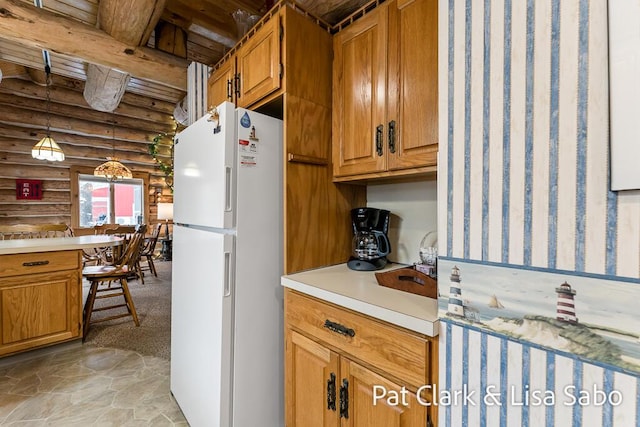 kitchen featuring beam ceiling, rustic walls, hanging light fixtures, white fridge, and light carpet