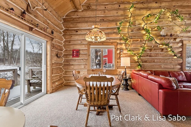 carpeted dining area with lofted ceiling with beams, an inviting chandelier, rustic walls, and wooden ceiling