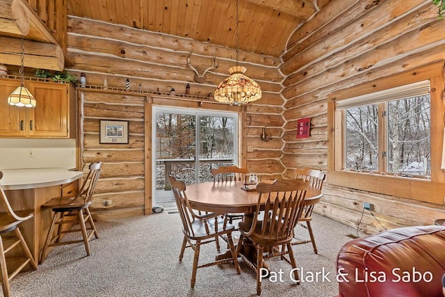 dining room featuring log walls and a healthy amount of sunlight