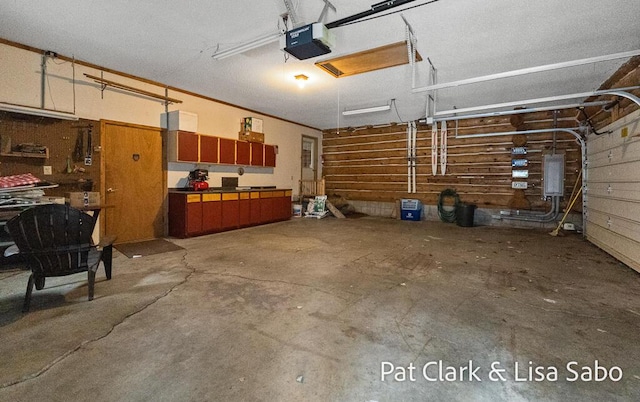 garage with electric panel and a garage door opener