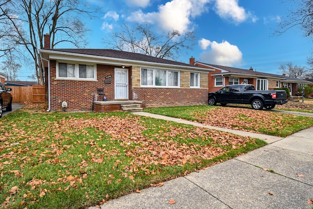 single story home featuring a front yard