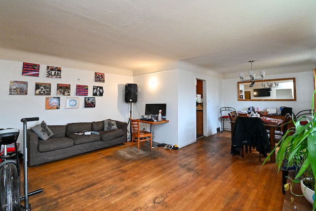 living room featuring dark wood-type flooring and a notable chandelier