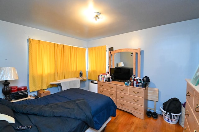 bedroom with hardwood / wood-style flooring