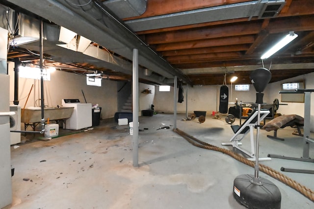 basement featuring washer / clothes dryer, plenty of natural light, and sink