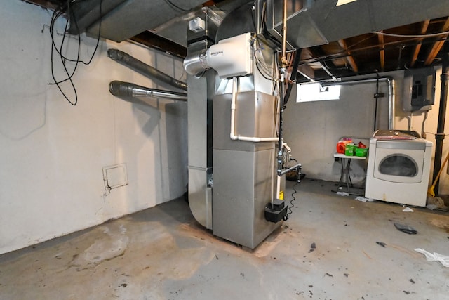 basement with electric panel, washer / clothes dryer, and heating unit