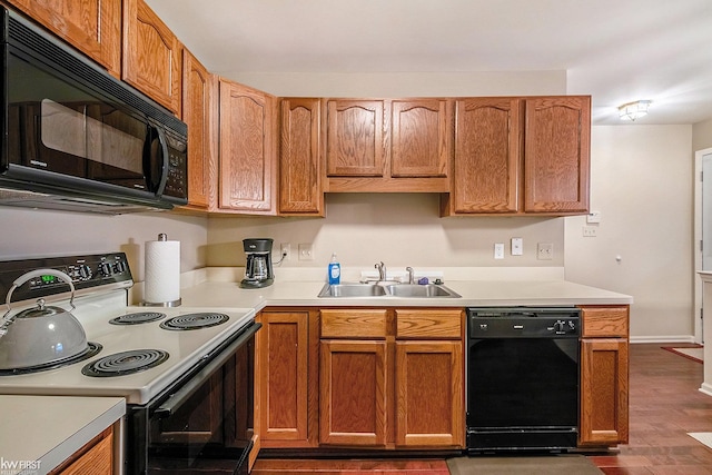 kitchen with dark hardwood / wood-style flooring, sink, and black appliances