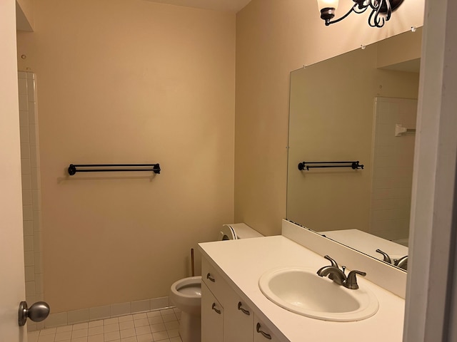 bathroom featuring tile patterned flooring, vanity, and toilet