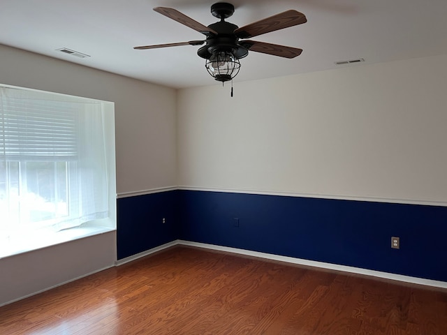 unfurnished room with hardwood / wood-style floors and ceiling fan