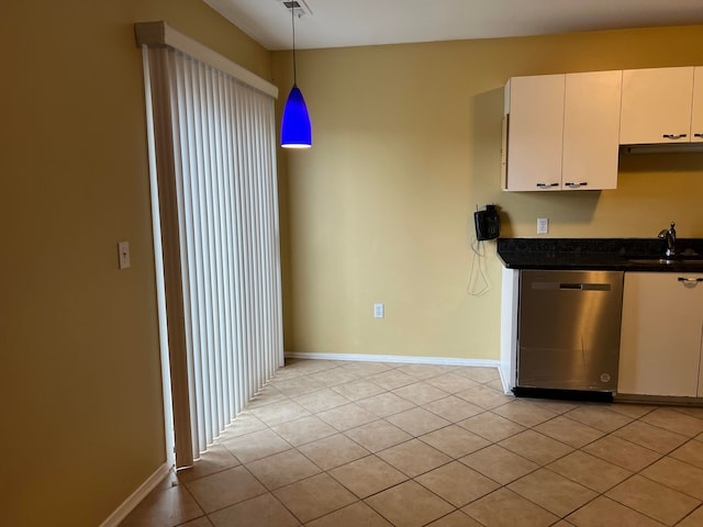 kitchen with sink, pendant lighting, light tile patterned floors, dishwasher, and white cabinetry