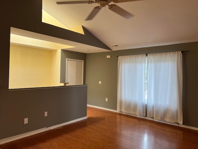 spare room featuring hardwood / wood-style flooring, ceiling fan, and lofted ceiling