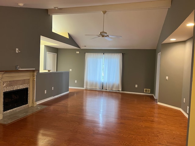 unfurnished living room featuring a tile fireplace, hardwood / wood-style floors, high vaulted ceiling, and ceiling fan