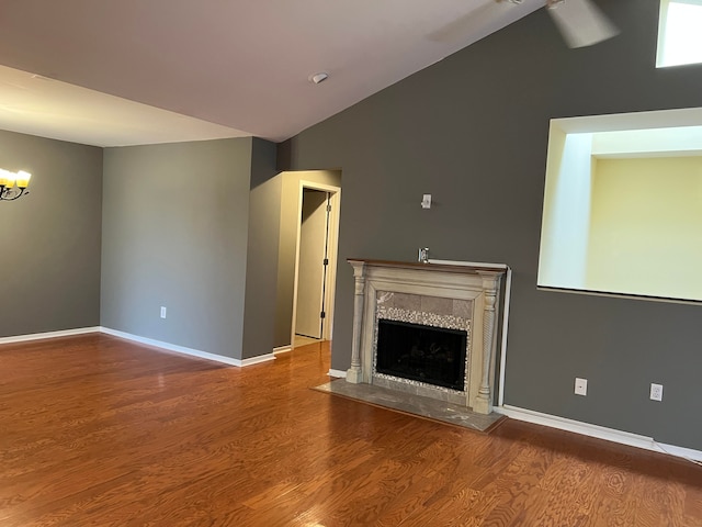 unfurnished living room featuring wood-type flooring and lofted ceiling