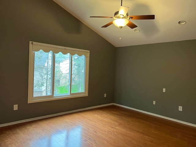 unfurnished room featuring ceiling fan, lofted ceiling, and light hardwood / wood-style flooring