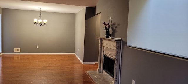 living room featuring wood-type flooring and an inviting chandelier