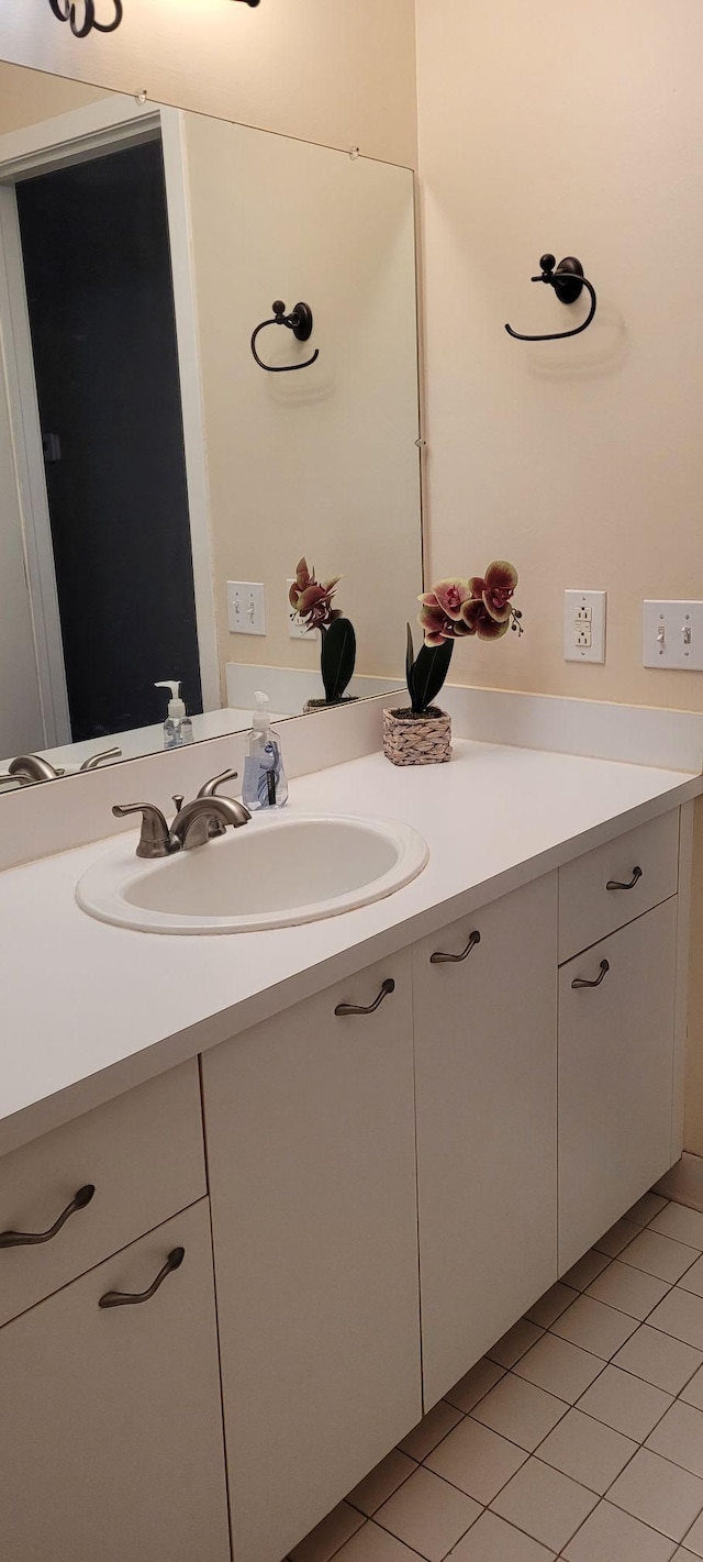 bathroom with tile patterned flooring and vanity