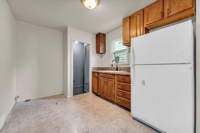 kitchen featuring white refrigerator and sink