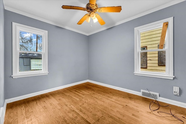 spare room featuring ceiling fan, wood-type flooring, and ornamental molding