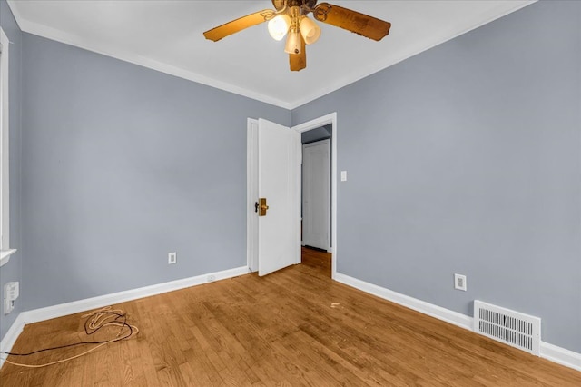 unfurnished room with ceiling fan, hardwood / wood-style floors, and ornamental molding