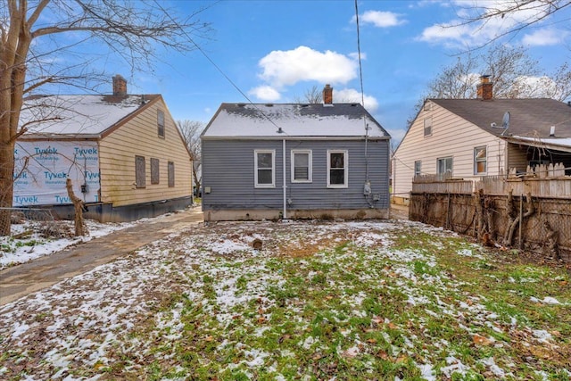 view of snow covered back of property