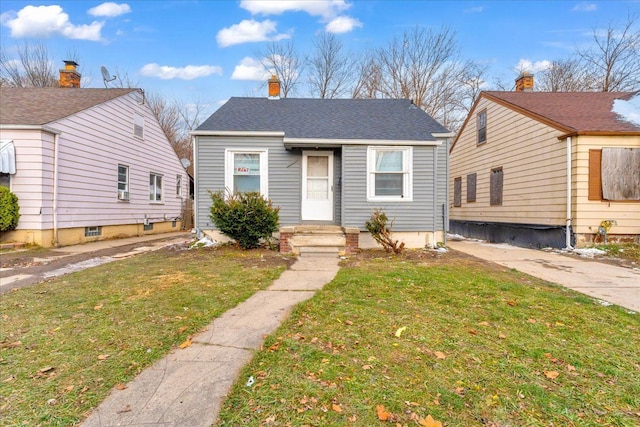 bungalow-style house with a front lawn