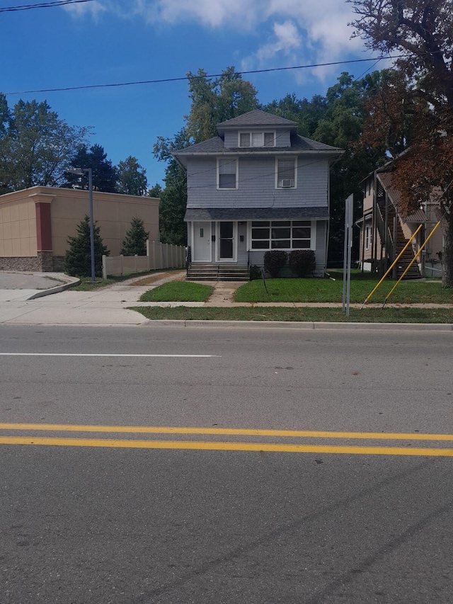 traditional style home featuring entry steps and fence