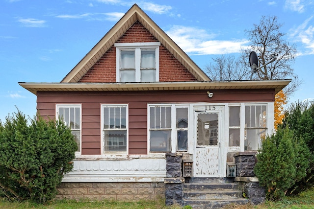 view of front of property featuring a sunroom