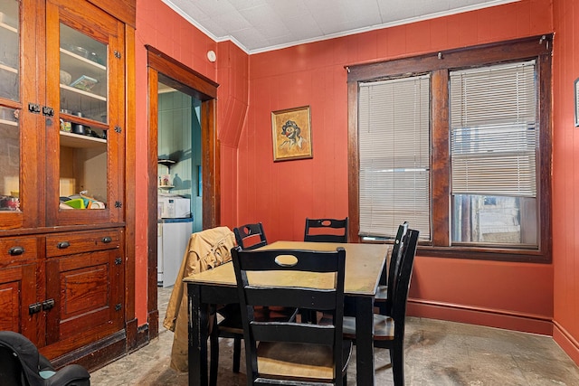 dining room featuring concrete floors and ornamental molding