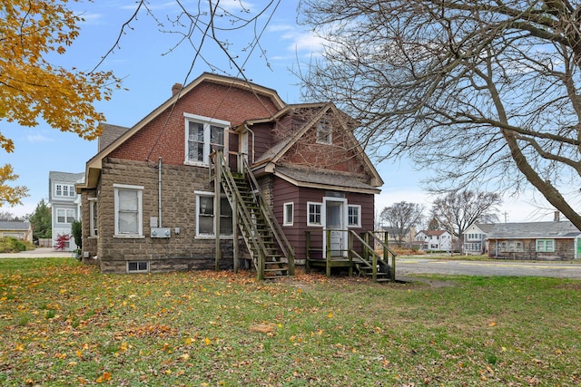 rear view of property with a yard