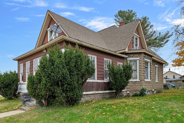 view of side of home with a lawn