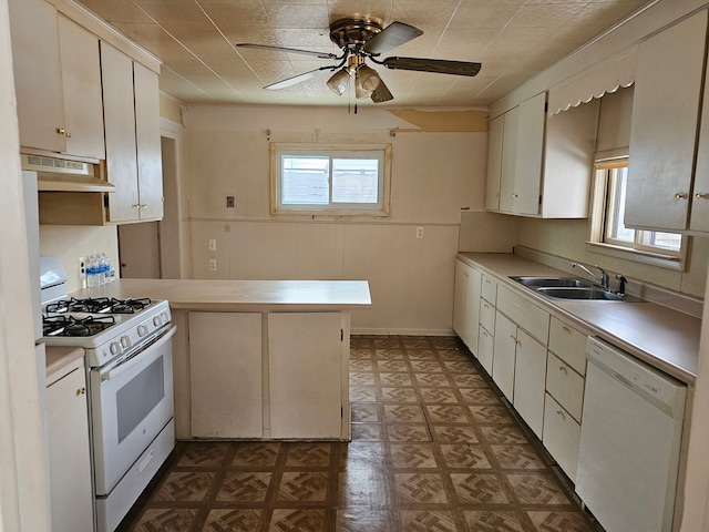 kitchen featuring kitchen peninsula, white appliances, sink, exhaust hood, and white cabinets