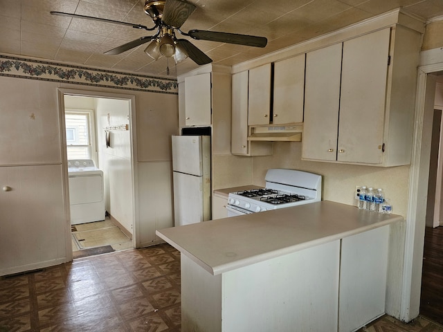 kitchen with ceiling fan, white appliances, kitchen peninsula, and washer / clothes dryer