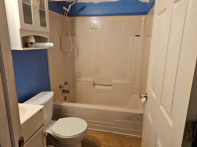 full bathroom featuring toilet, hardwood / wood-style floors, vanity, and bathing tub / shower combination