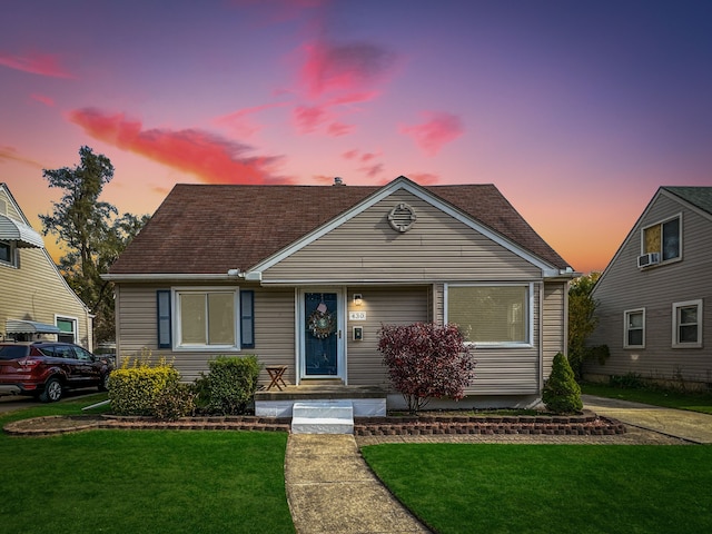 bungalow-style home with a lawn