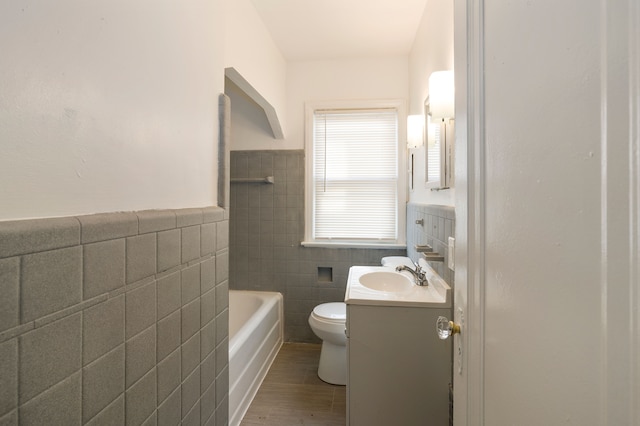 bathroom featuring hardwood / wood-style flooring, vanity, toilet, and tile walls