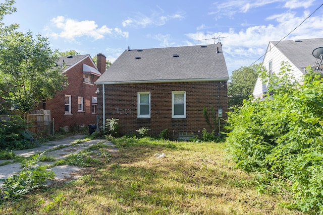 rear view of house with a yard