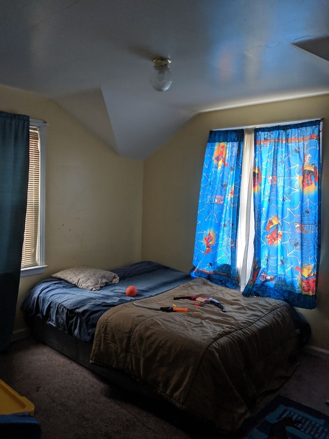 carpeted bedroom with vaulted ceiling