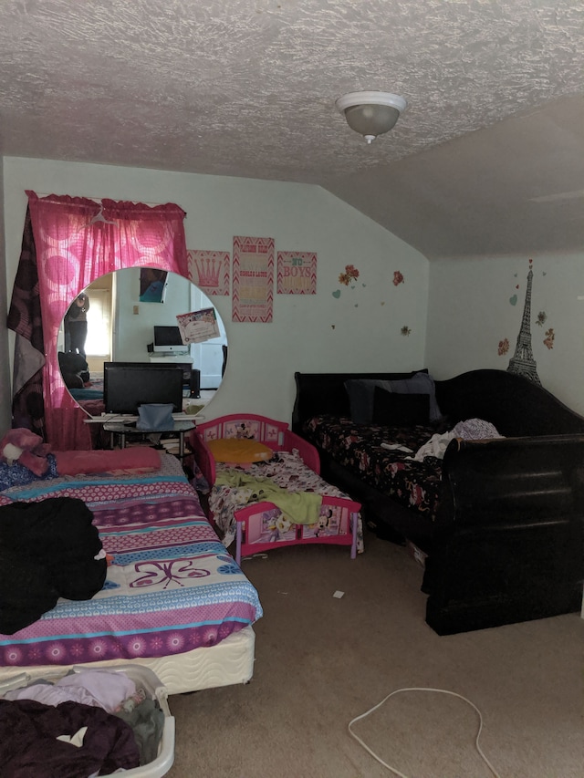 bedroom with a textured ceiling, carpet floors, and vaulted ceiling