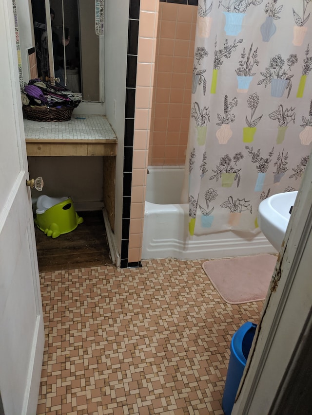 bathroom featuring shower / bath combination with curtain and wood-type flooring