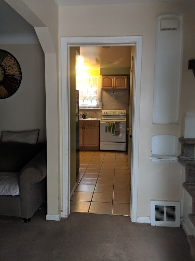 hallway featuring light tile patterned floors