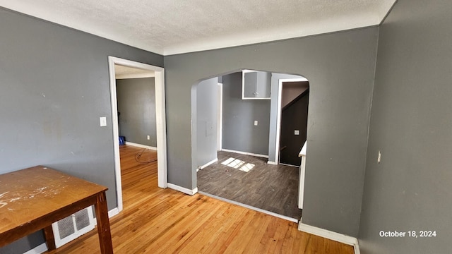 entryway featuring a textured ceiling and hardwood / wood-style flooring