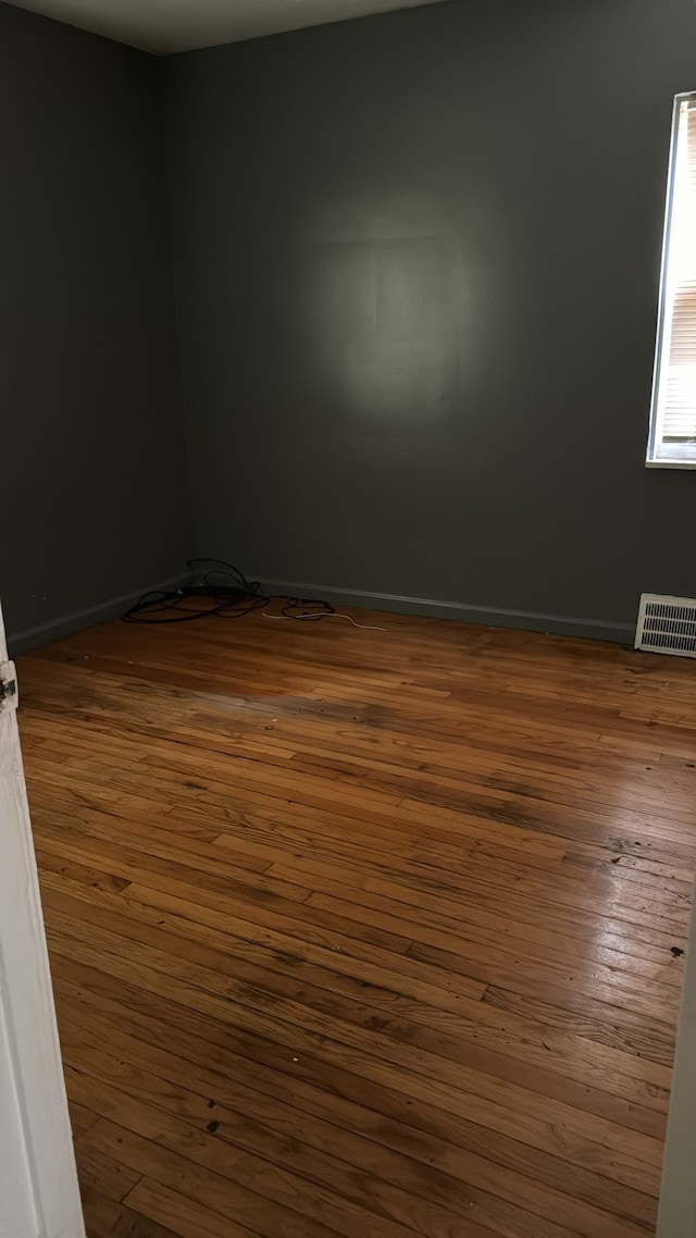 empty room featuring dark hardwood / wood-style flooring