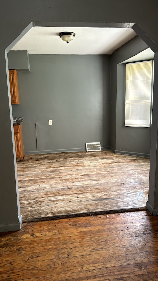 unfurnished room featuring hardwood / wood-style flooring