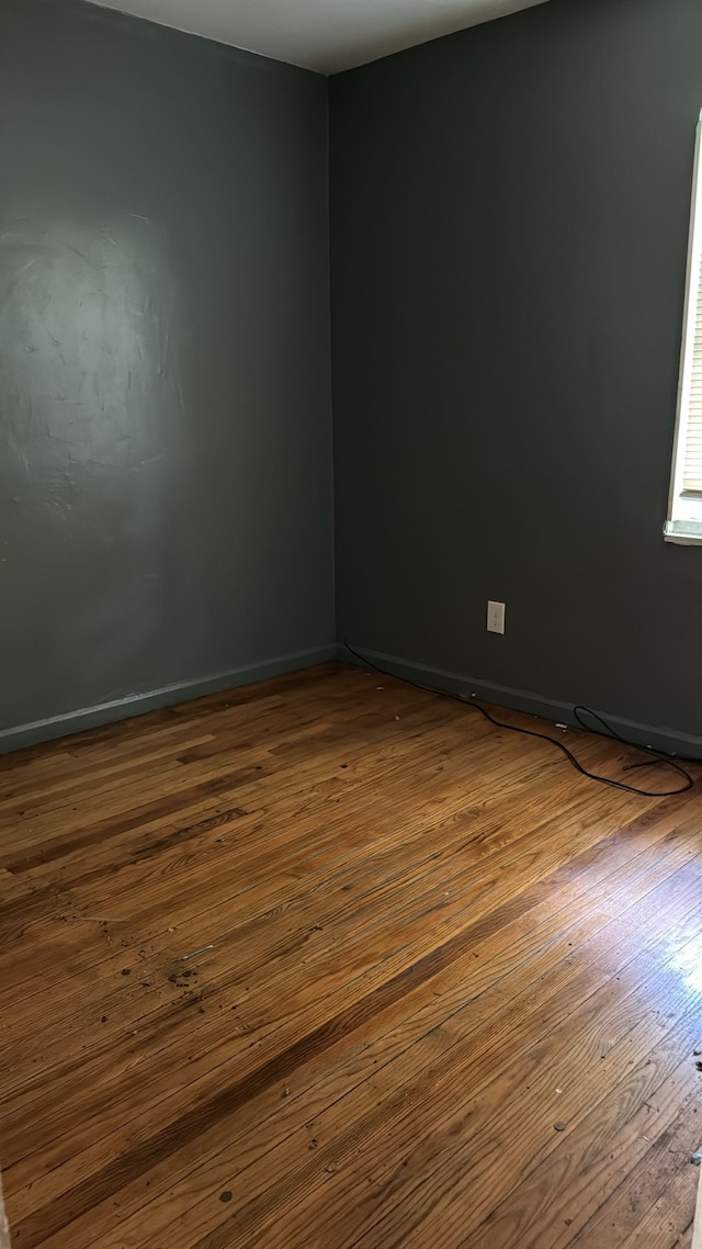 empty room featuring dark wood-type flooring